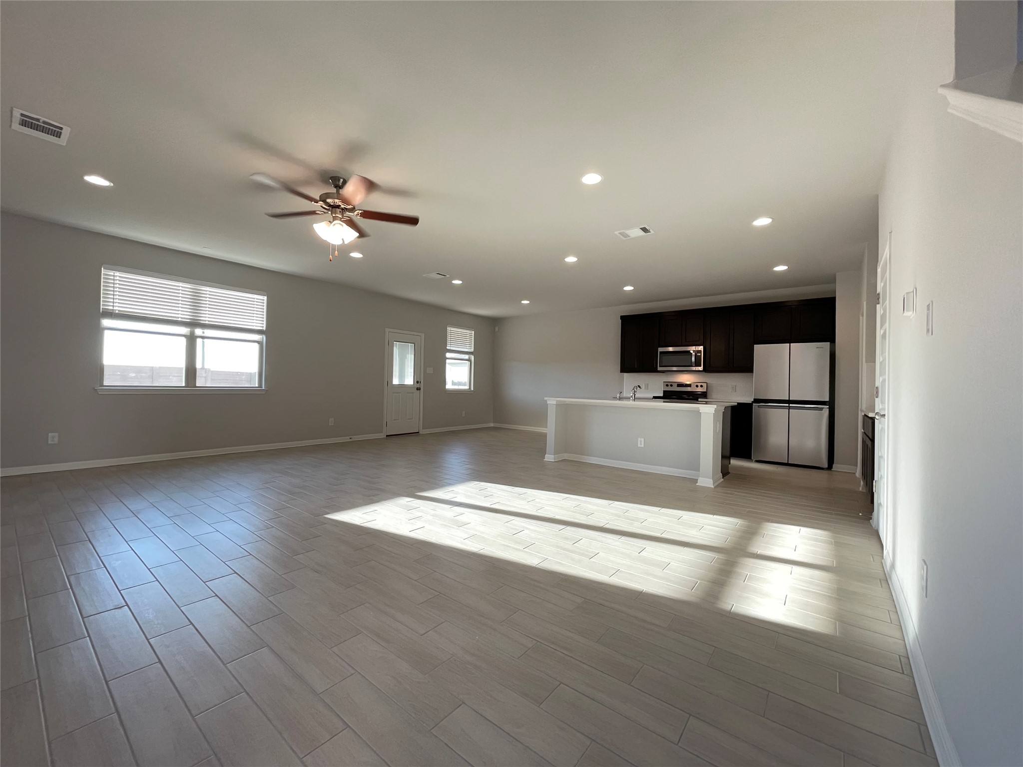 125 Old Stagecoach Road Jarrell, TX 76537 - Photo 12 of 31 a view of an empty room with kitchen and window