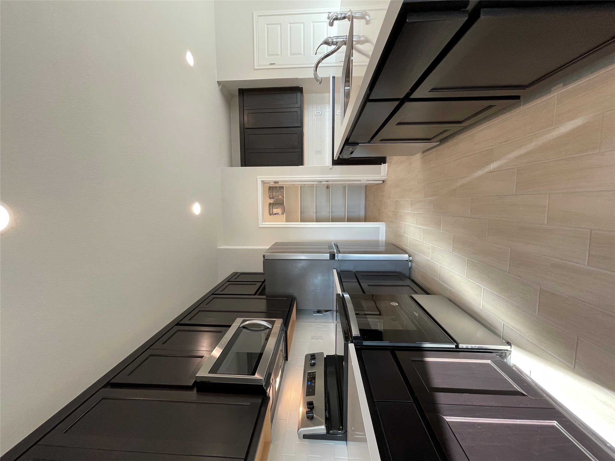 125 Old Stagecoach Road Jarrell, TX 76537 - Photo 13 of 31 a large kitchen with stainless steel appliances and a stove top oven