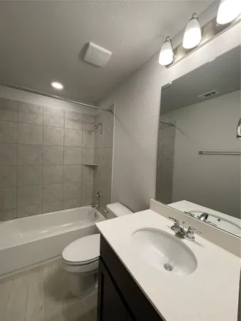 a view of an empty room with a chandelier fan