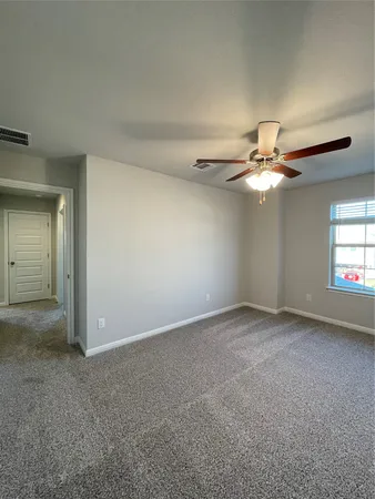 a view of a livingroom with a ceiling fan and window