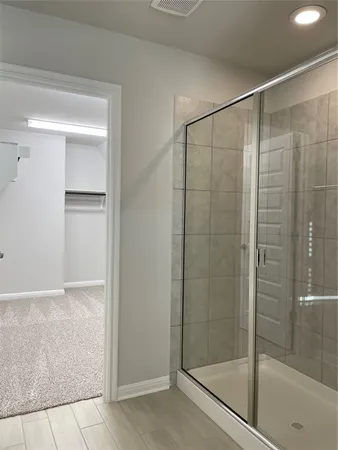 a bathroom with a granite countertop toilet and a shower