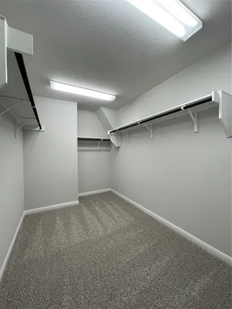 a view of a livingroom with a ceiling fan and window