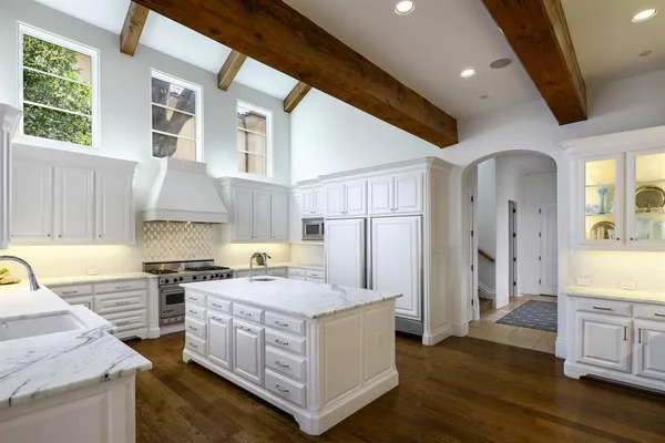 a kitchen with stainless steel appliances granite countertop a stove and a refrigerator