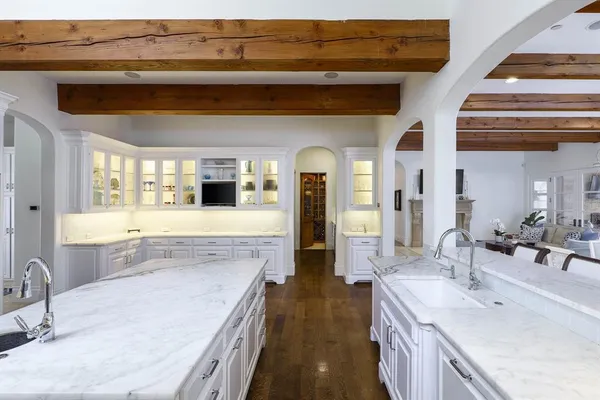 a bathroom with a granite countertop sink a large mirror and vanity