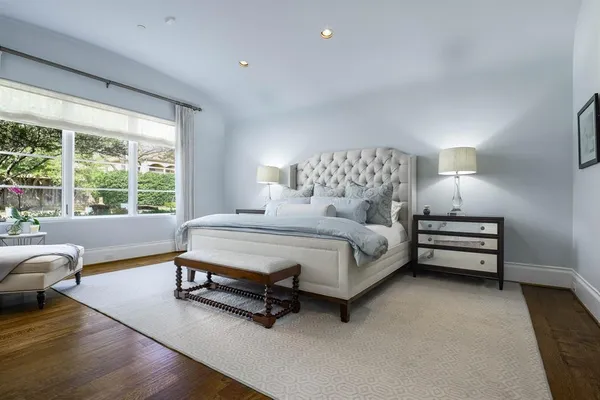 a bedroom with a bed a couch and a night stand