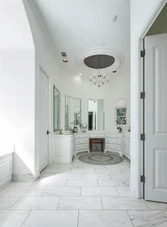 a large bathroom with a tub and window