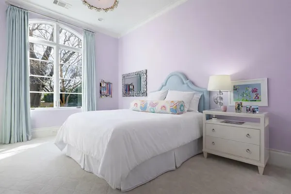 a bedroom with a bed and a large window