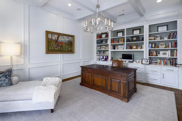a living room with furniture and a bookshelf