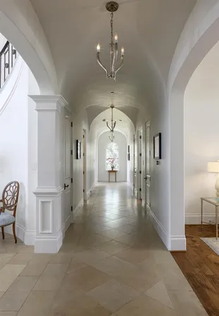 a view of a hallway with entryway windows and a livingroom