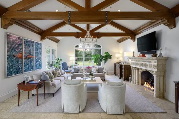 a living room with furniture a fireplace and a flat screen tv