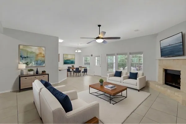 a living room with furniture a fireplace and a flat screen tv