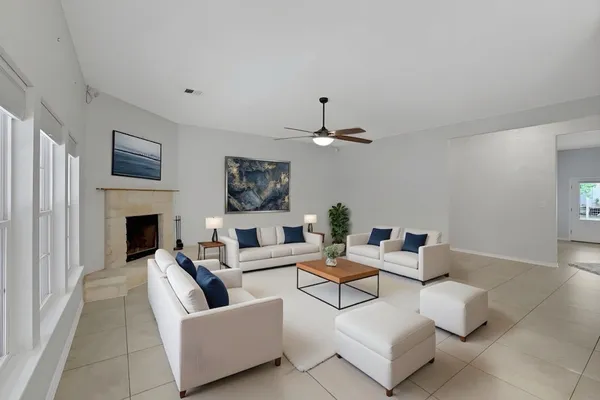 a living room with furniture and a fireplace