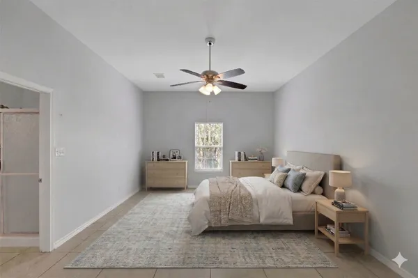 a bedroom with a bed and a ceiling fan