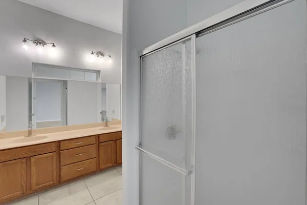 a spacious bathroom with a shower and a sink