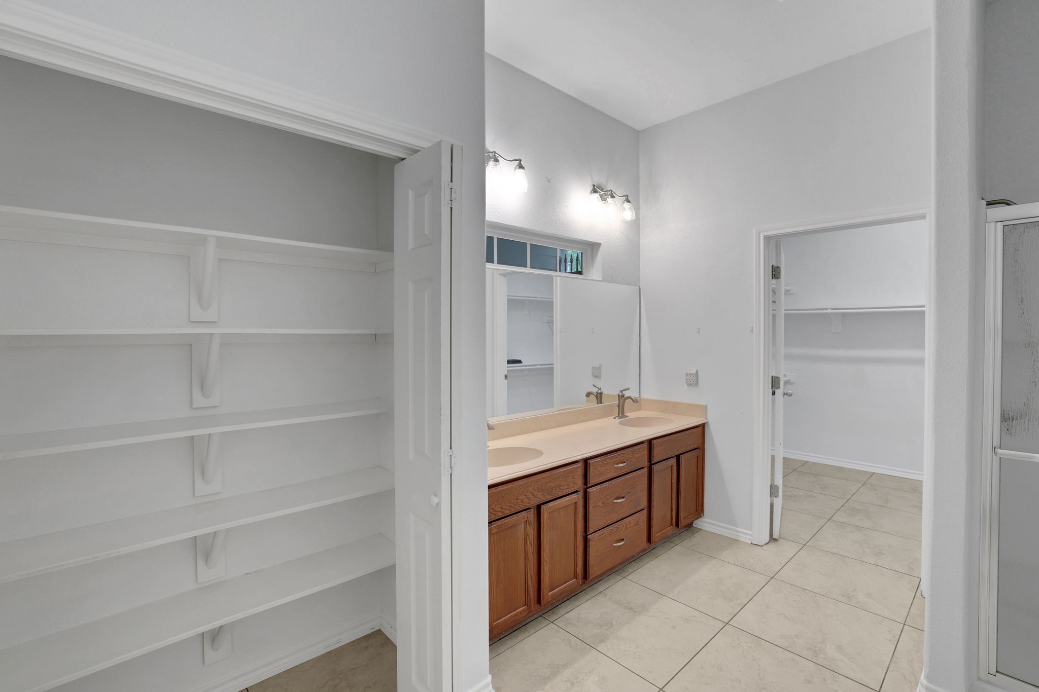 1290 Spring Ridge Road Coldspring, TX 77331 - Photo 28 of 49 The primary ensuite bathroom has dual vanities and good storage