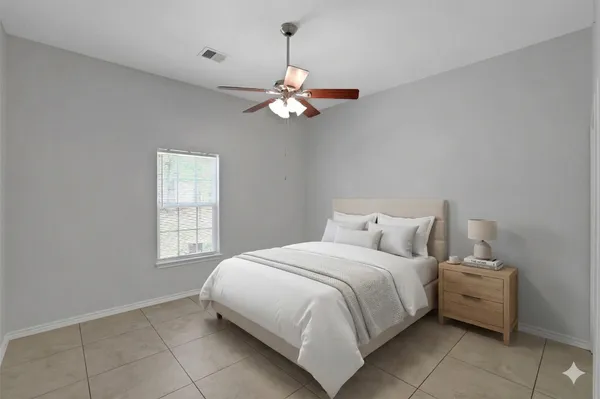 a bedroom with a bed and window