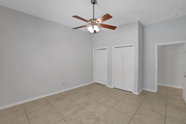 a view of a chandelier fan and entryway
