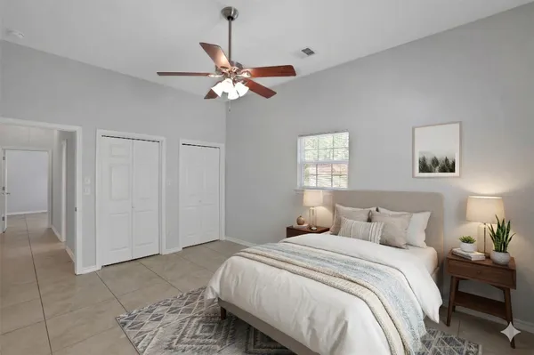 a bedroom with a bed and a chandelier