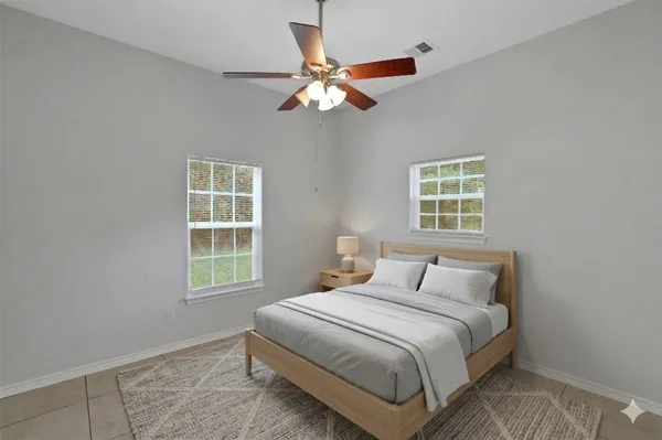 a bedroom with a large bed and a window