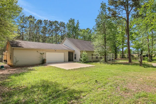 a front view of house with yard and trees