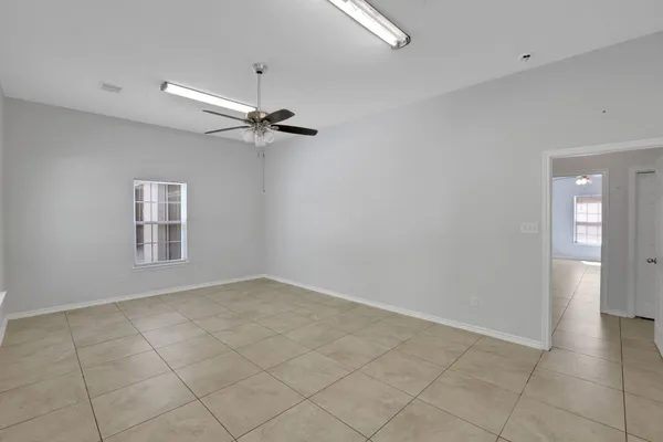 a view of an empty room with a ceiling fan