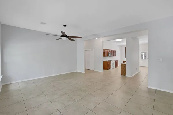 a view of a kitchen with furniture and an empty room