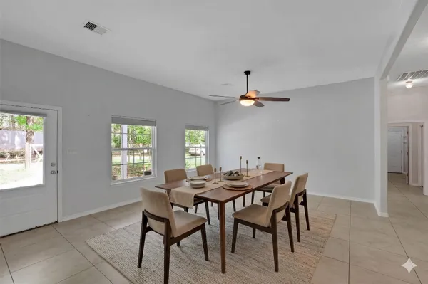 a view of a dining room with furniture and window