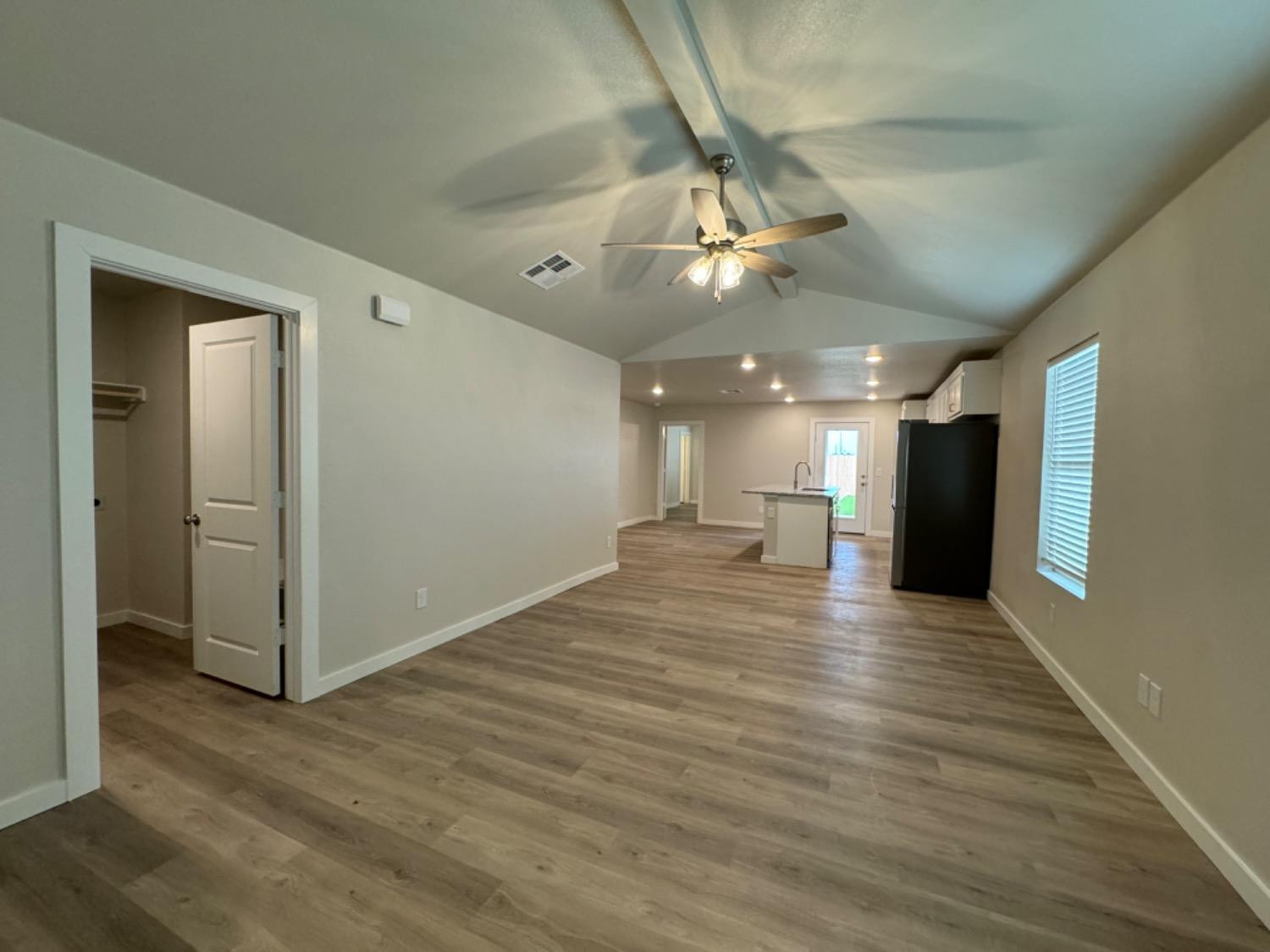 327 East 77th Street Lubbock, TX 79404 - Photo 1 of 1 a view of a livingroom with a ceiling fan wooden floor and staircase