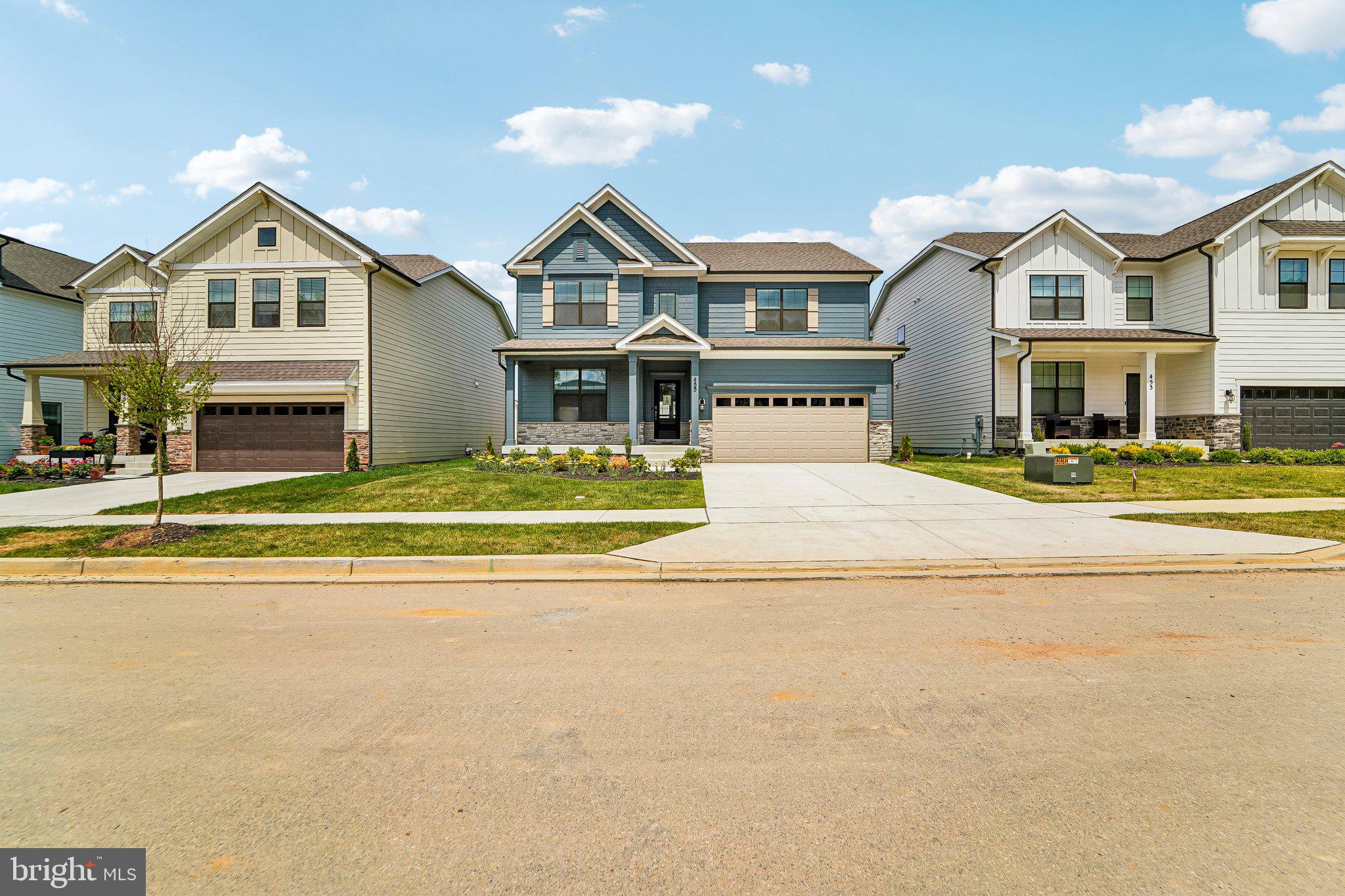 a front view of residential houses with yard and swimming pool