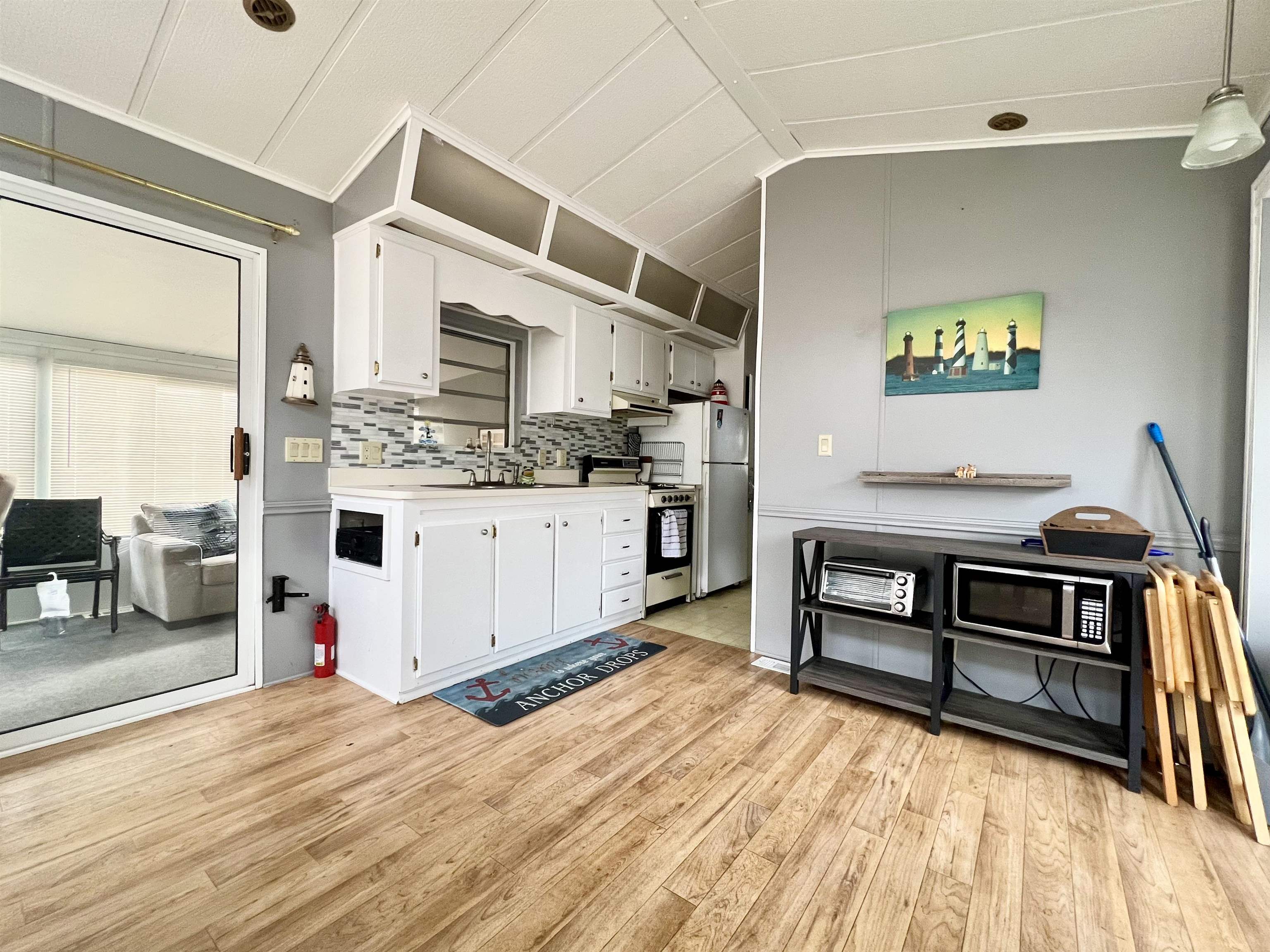 709 Seashore Road Cape May, NJ 08204 - Photo 11 of 29 a living room with stainless steel appliances kitchen island granite countertop a stove and a sink