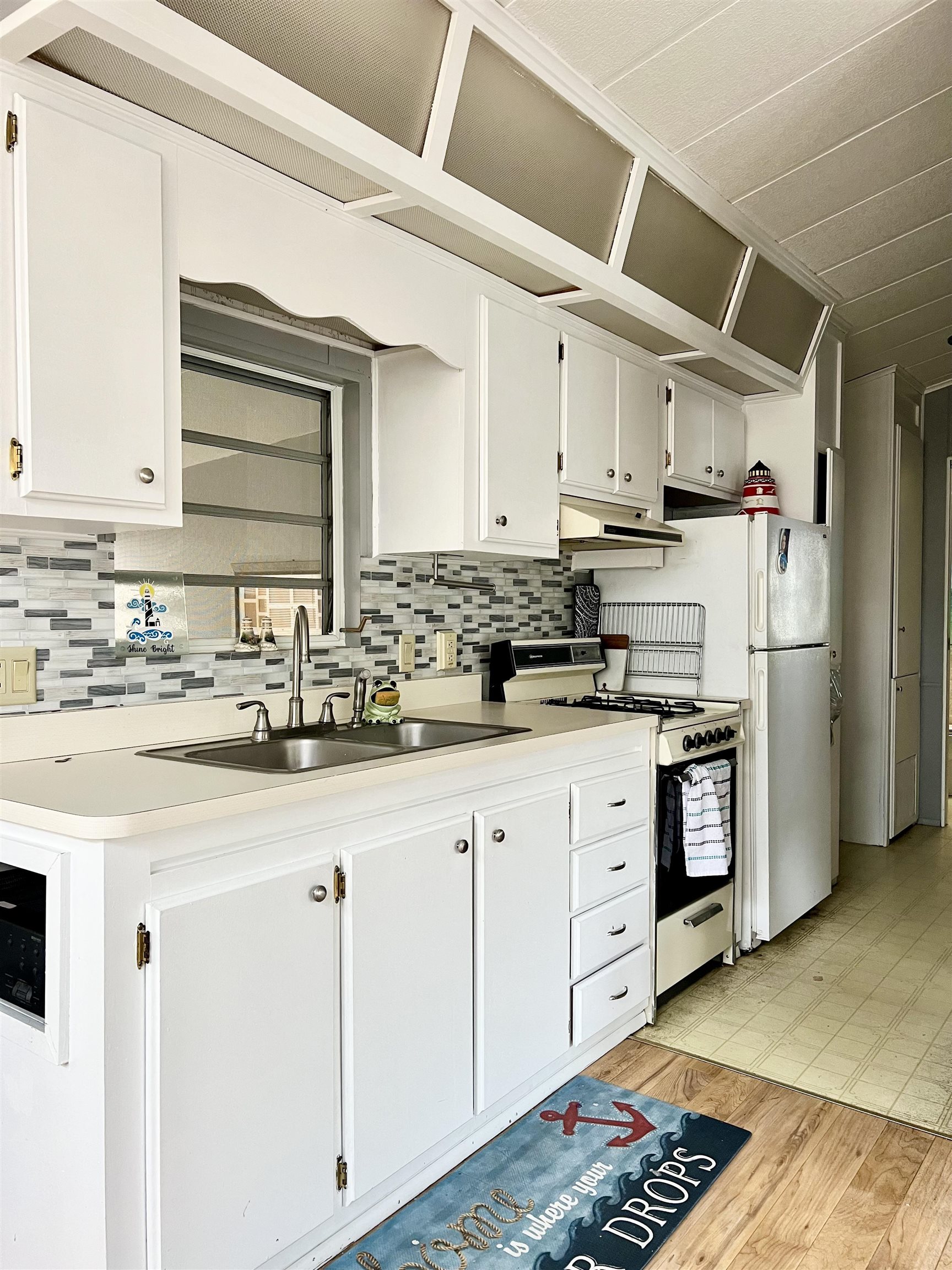709 Seashore Road Cape May, NJ 08204 - Photo 12 of 29 a kitchen with stainless steel appliances kitchen island granite countertop a refrigerator and cabinets