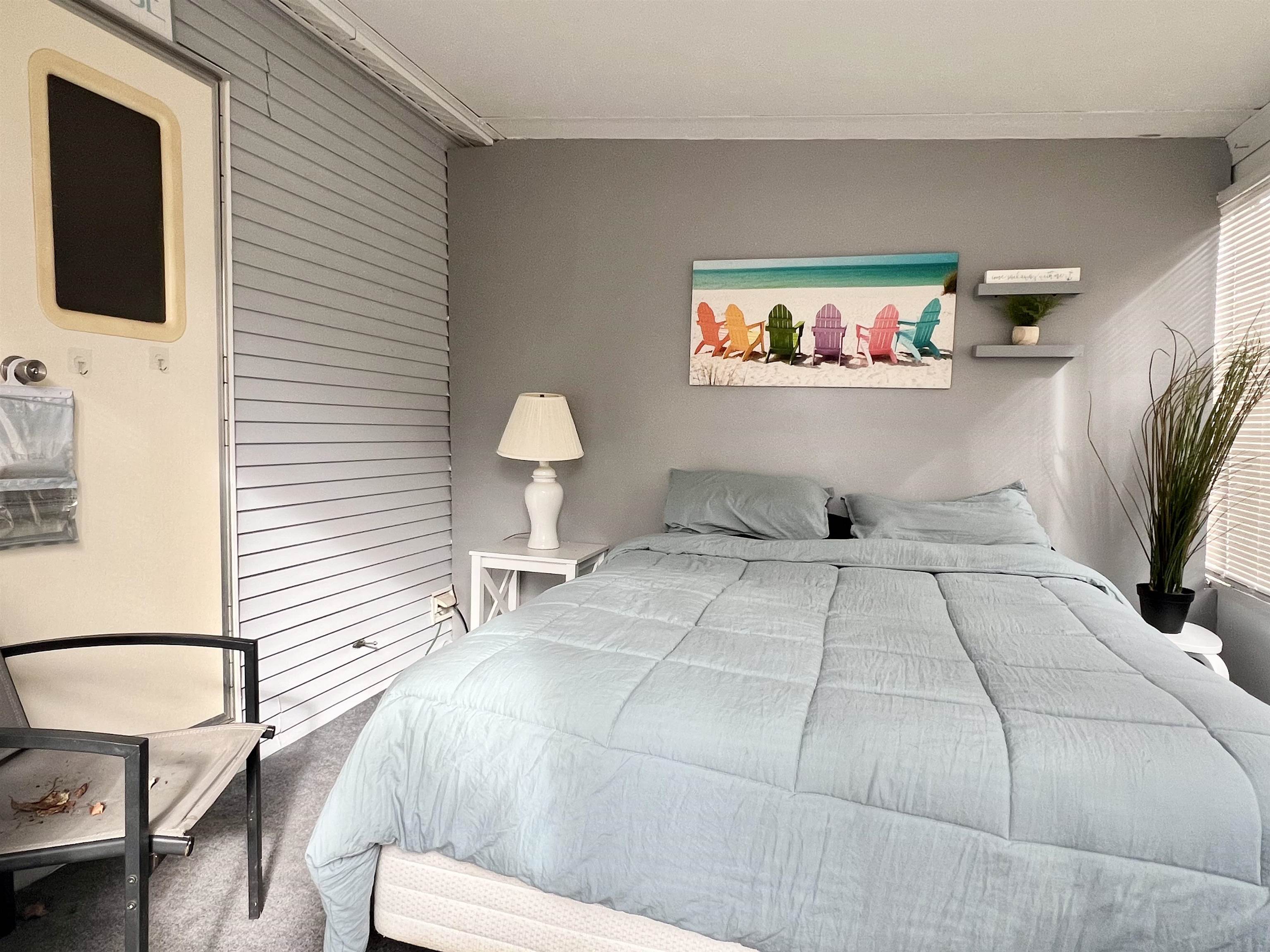 709 Seashore Road Cape May, NJ 08204 - Photo 14 of 29 a bedroom with a bed and a flat screen tv