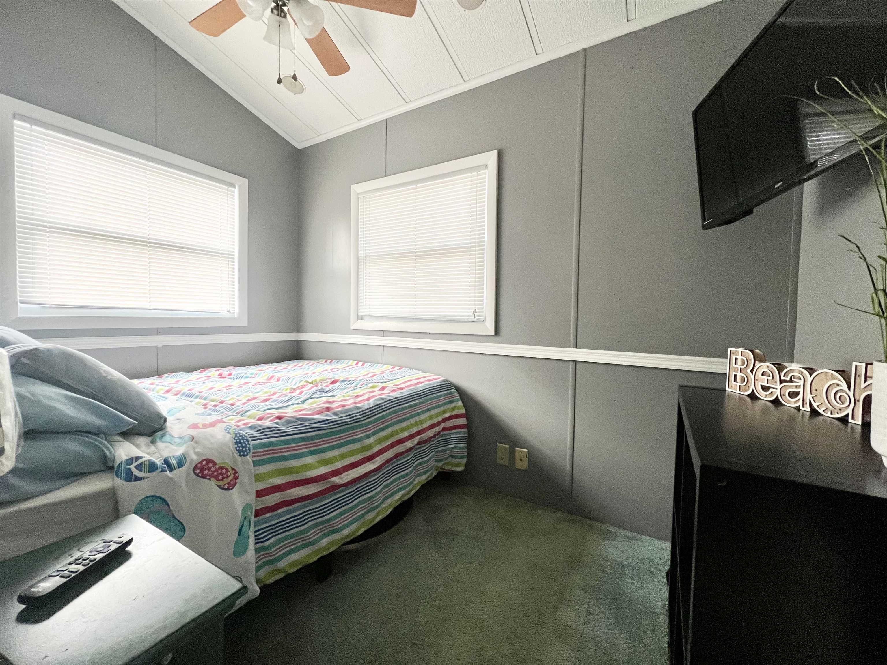 709 Seashore Road Cape May, NJ 08204 - Photo 17 of 29 a bedroom with a bed and flat screen tv