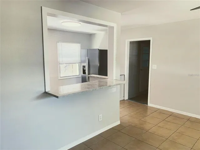a kitchen with a refrigerator and a sink