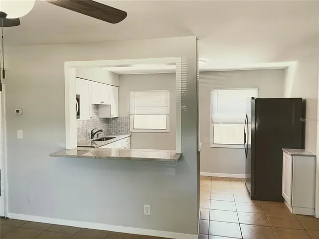 a kitchen with a refrigerator and a sink