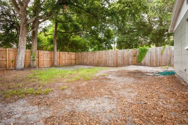 a living room with furniture a chandelier and a window