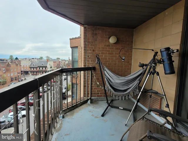 a kitchen with stainless steel appliances granite countertop a sink a stove a refrigerator and white cabinets