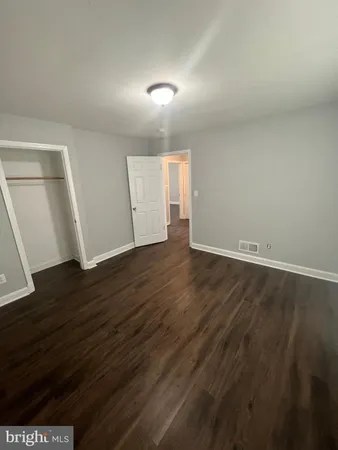 an empty room with wooden floor