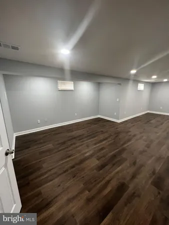 an empty room with wooden floor