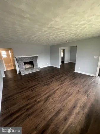 a view of an empty room and wooden floor