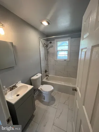 a bathroom with a toilet sink and shower