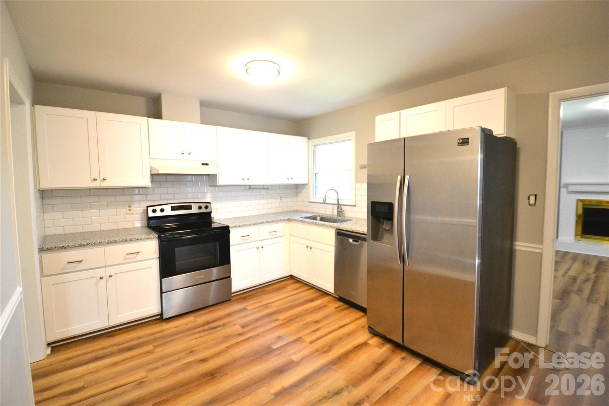 1422 Thermal Road Charlotte, NC 28212 - Photo 14 of 40 a kitchen with a refrigerator stove and sink