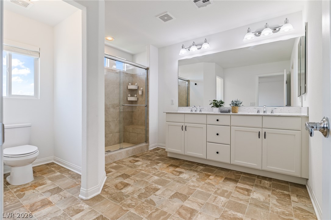 5510 Ripple Ridge Avenue Las Vegas, NV 89139 - Photo 29 of 45 This spacious primary bathroom offers elegant finishes and a convenient dual vanity, enhancing daily routines.