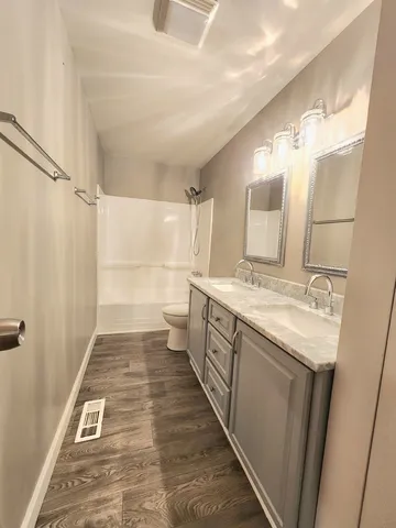 a bathroom with a sink a mirror and a shower