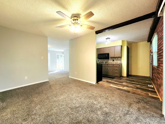 a view of a kitchen with a sink and a refrigerator