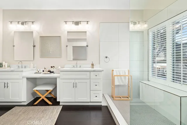 a spacious bathroom with a granite countertop sink mirror and bathtub