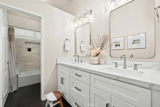 a bathroom with a double vanity sink and a mirror