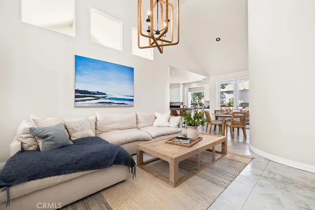 a living room with furniture a rug and a wall painting