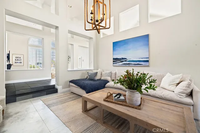 a living room with furniture flowerpot and a window