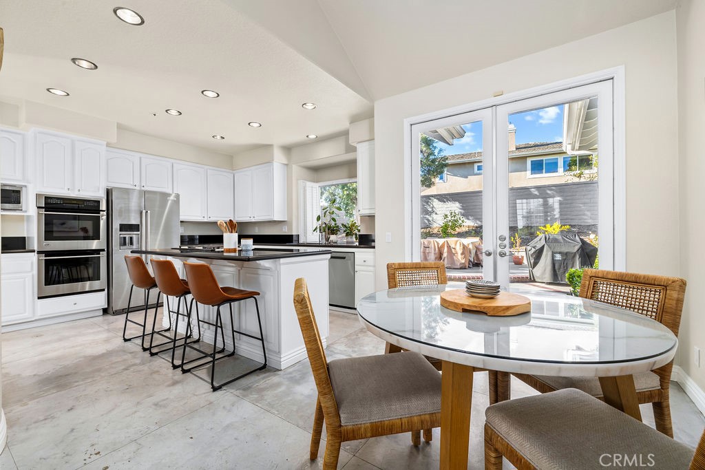 1 Via Colorso San Clemente, CA 92672 - Photo 6 of 24 a kitchen with a dining table chairs and refrigerator